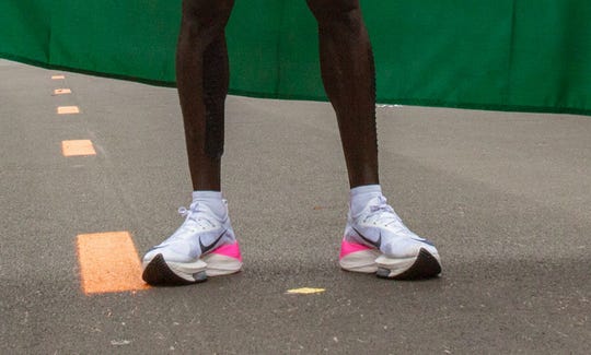 This file photograph taken on Oct. 12, 2019, shows the running shoes of Kenya's Eliud Kipchoge as he stands after his attempt to break the two-hour barrier for the marathon at The Reichsbrücke in Vienna. (Photo by ALEX HALADA / AFP)
