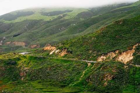 Runners along the Big Sur Marathon course in Big Sur, California in 2018.