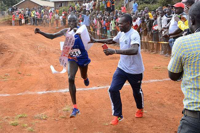  ndrew wemoi crosses the line in first to win the mens 10km race during the eamganda okyo 2020 run at the oma round