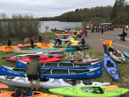 Athletes prepare their kayaks for the first leg of the White Deer Triathlon in Boulder Junction.