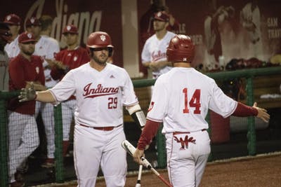 Then-senior catcher Ryan Fineman prepares to high-five senior utility Matt Lloyd on May 16, 2019, at Bart Kaufman Field. IU won two of its three games during the Keith Leclair Classic this weekend in Greenville, North Carolina.