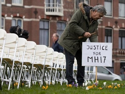 MH17 relatives protest over lack of Russian action with 298 empty chairs