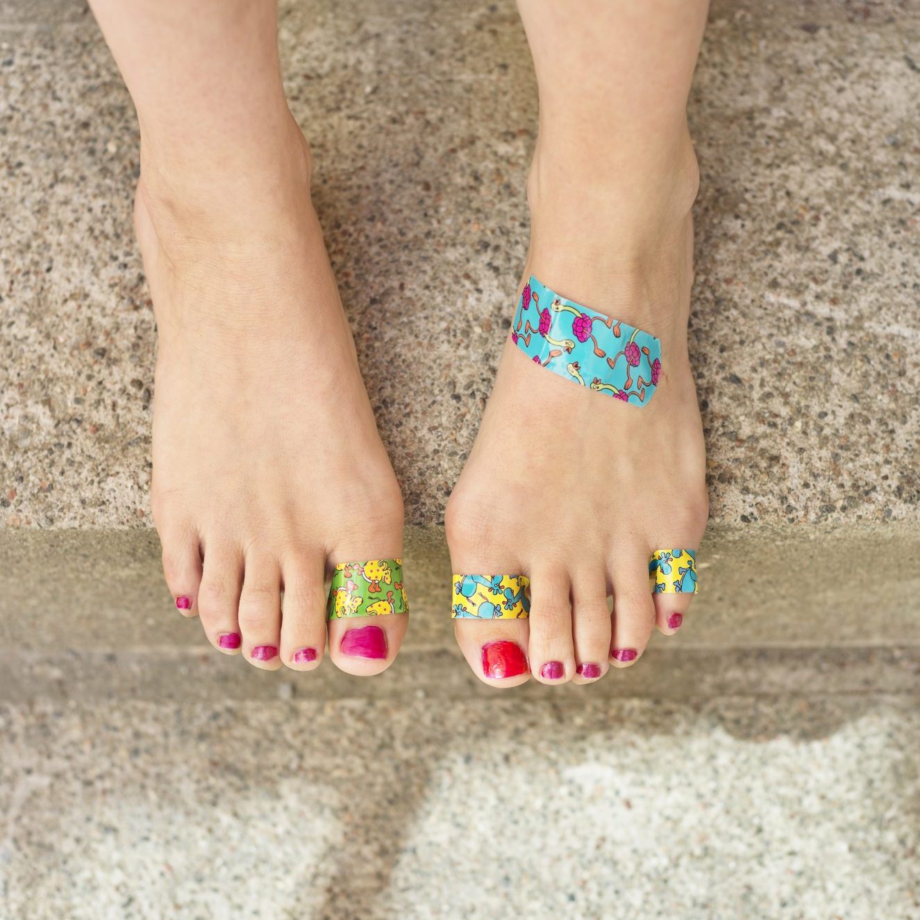 woman-with-blisters-and-bandaids-on-feet-from-running-in-bad-shoes