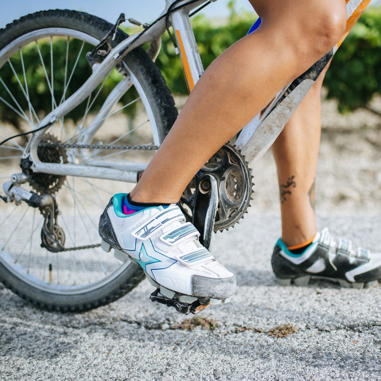 Close-up legs of female cyclist with cycling shoes bad shoes for foot pain