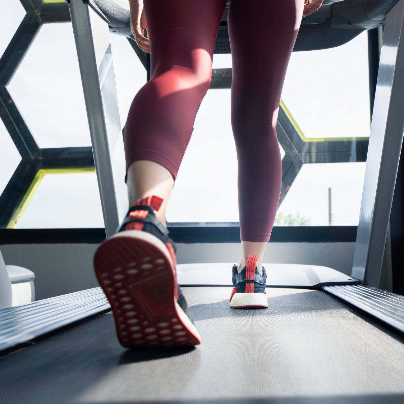 woman running on treadmill in bad shoes