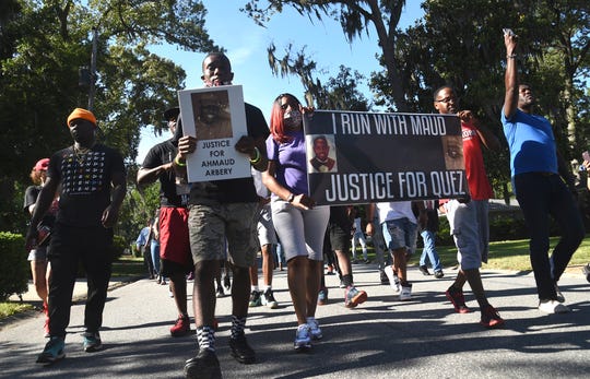 A crowd marches through a neighborhood in Brunswick, Ga. on May 5, 2020. They were demanding answers in the death of Ahmaud Arbery. An outcry over the Feb. 23 shooting of Arbery has intensified after cellphone video that lawyers for Arbery's family say shows him being shot to death by two white men.