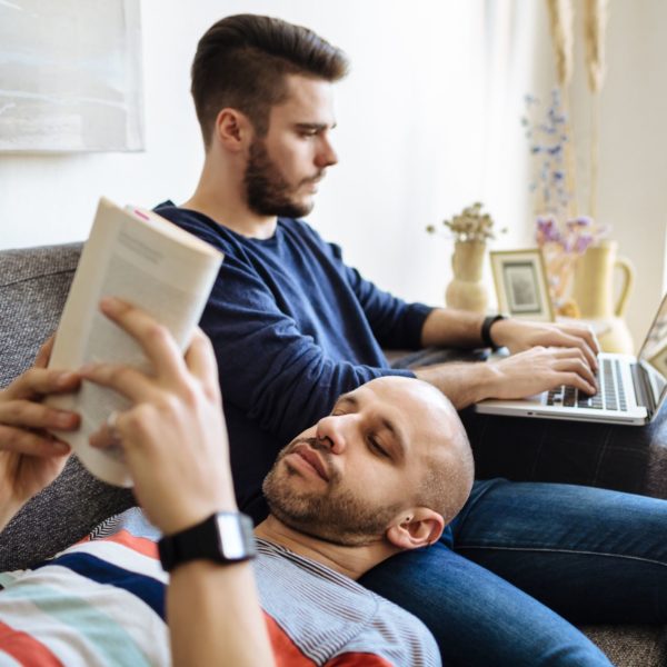 Gay Couple Enjoying Togetherness On Sofa