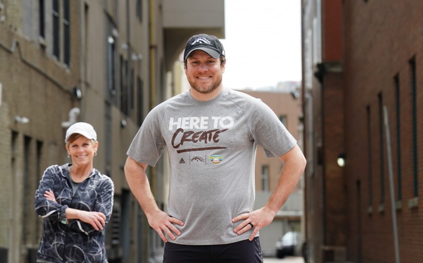 A man and woman pose in downtown Kalamazoo.