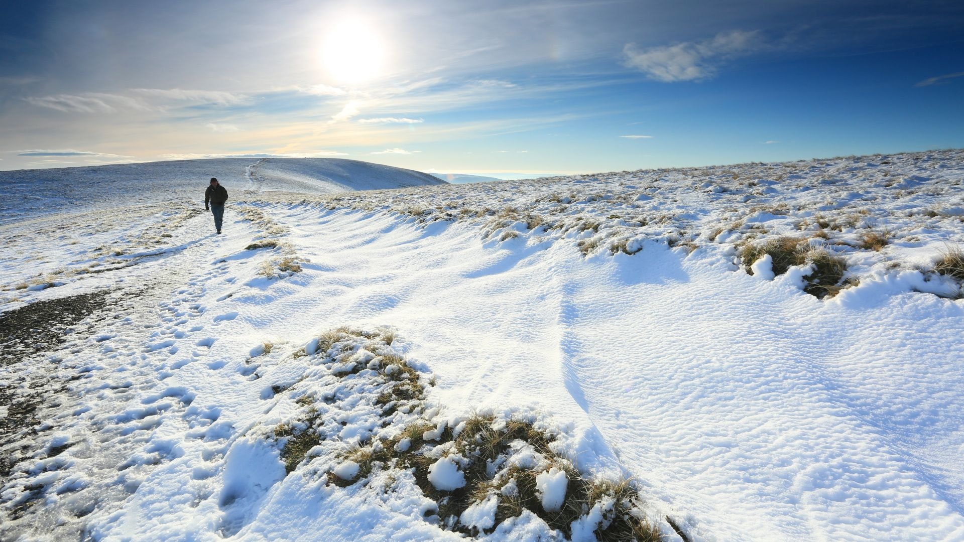 Hiker walking Bram Rigg Top Howgill Hills in winter
