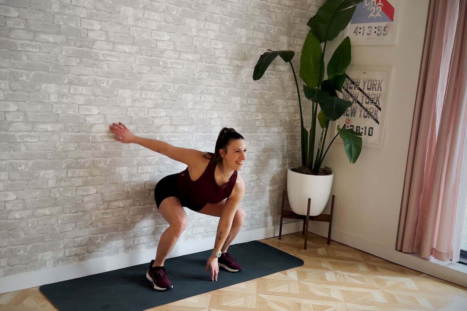 aerobic workout, amber rees performs the pop squat exercise