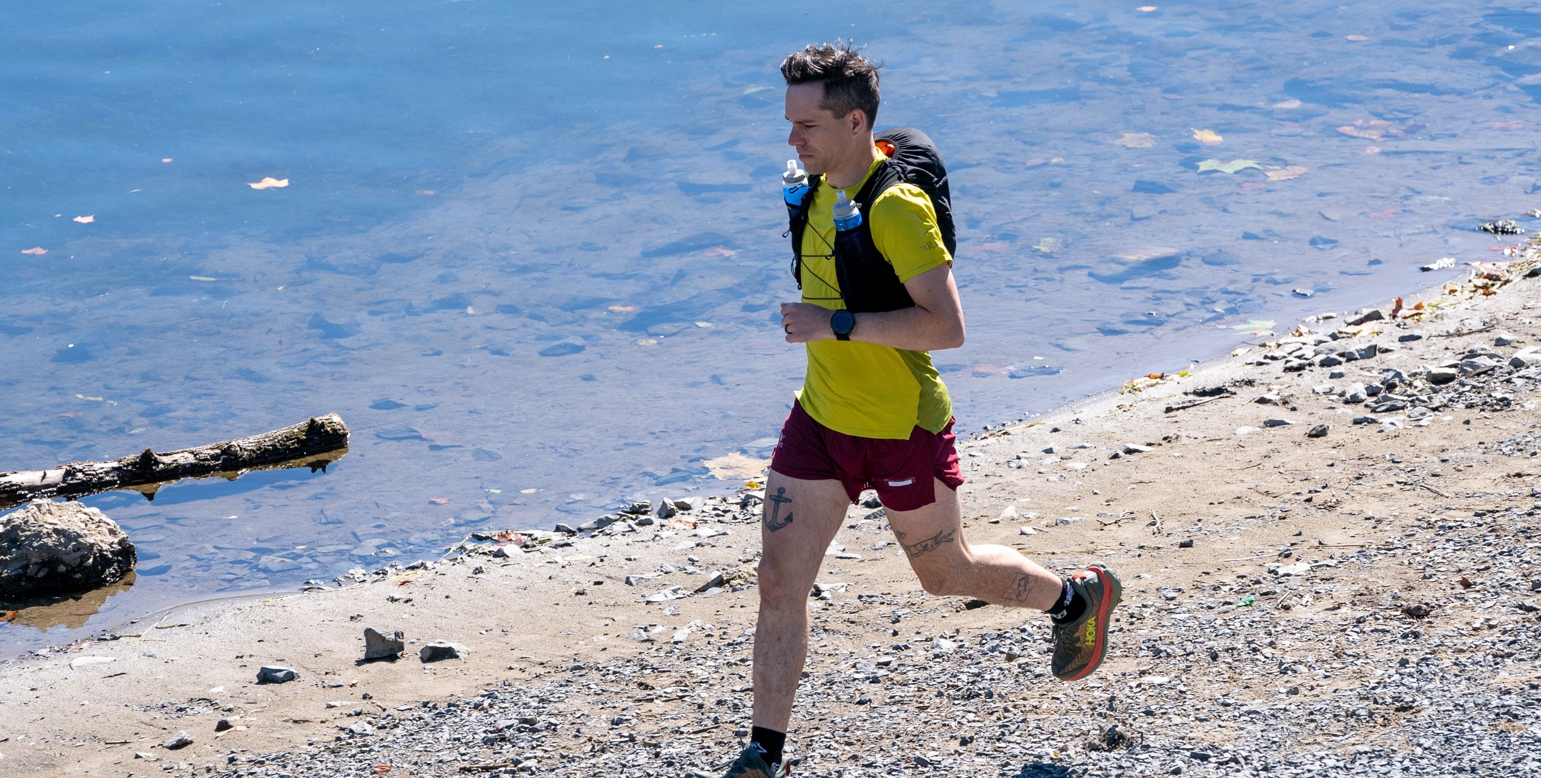 ultrarunner running along a river bank, guide to ultrarunning