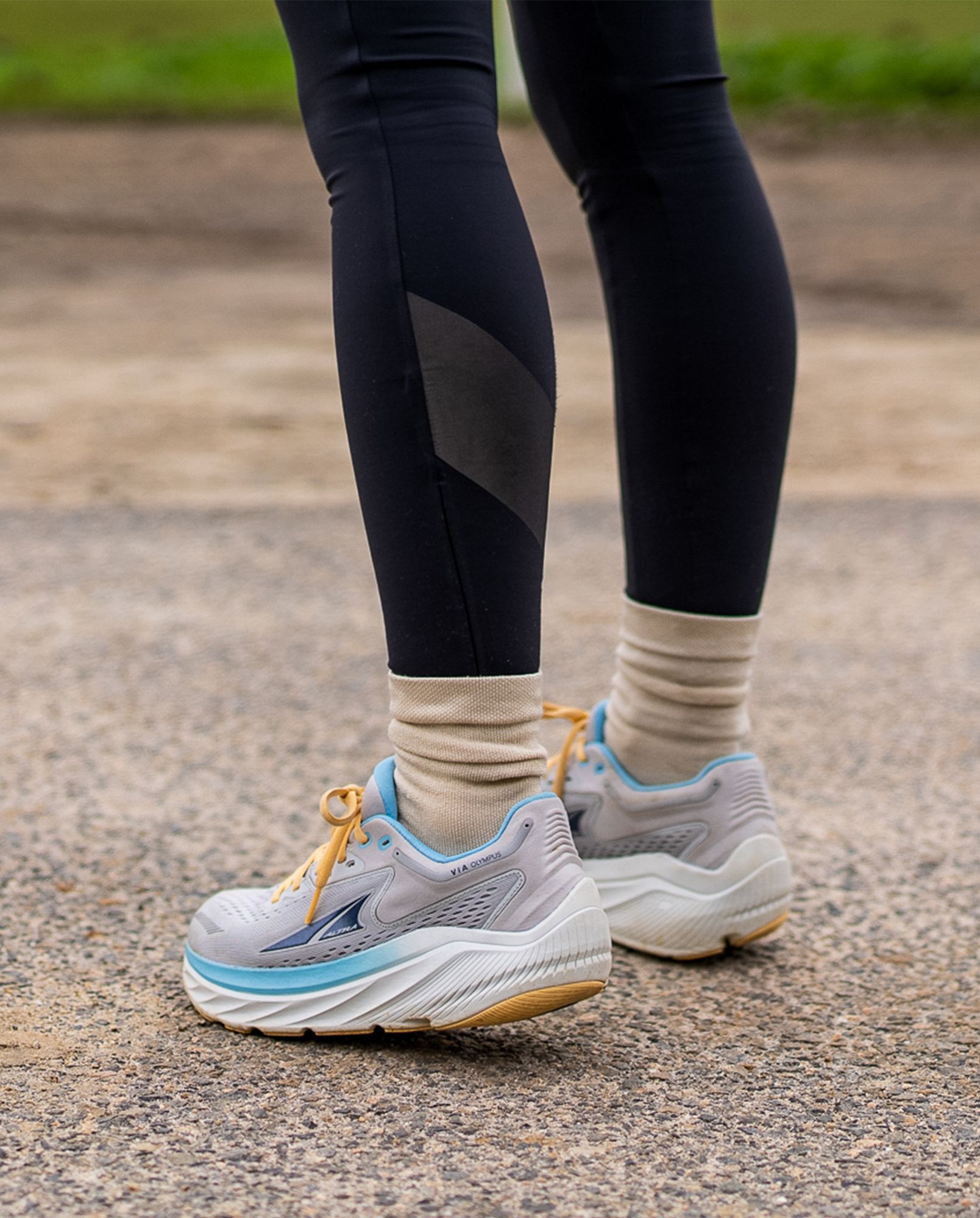 a woman wearing altra via olympus shoes