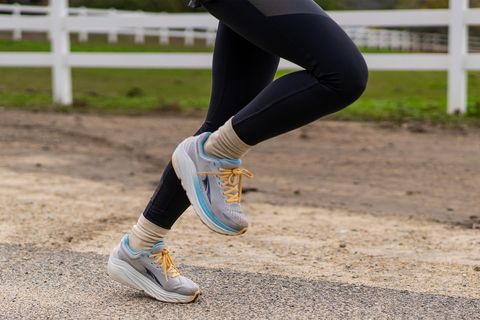 a woman running in altra via olympus shoes