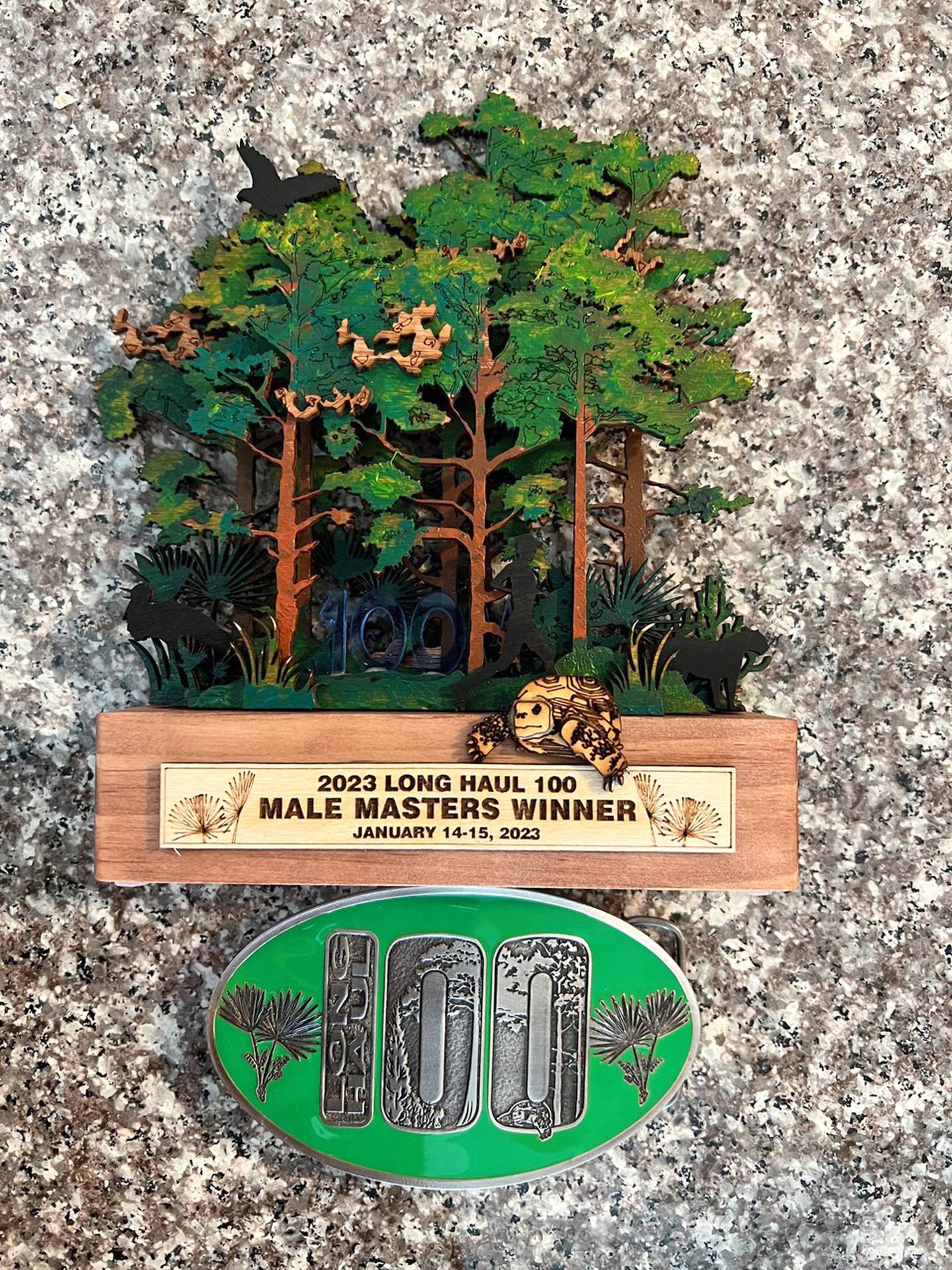 Pictured is the Long Haul 100 award and belt buckle given to all finishers.