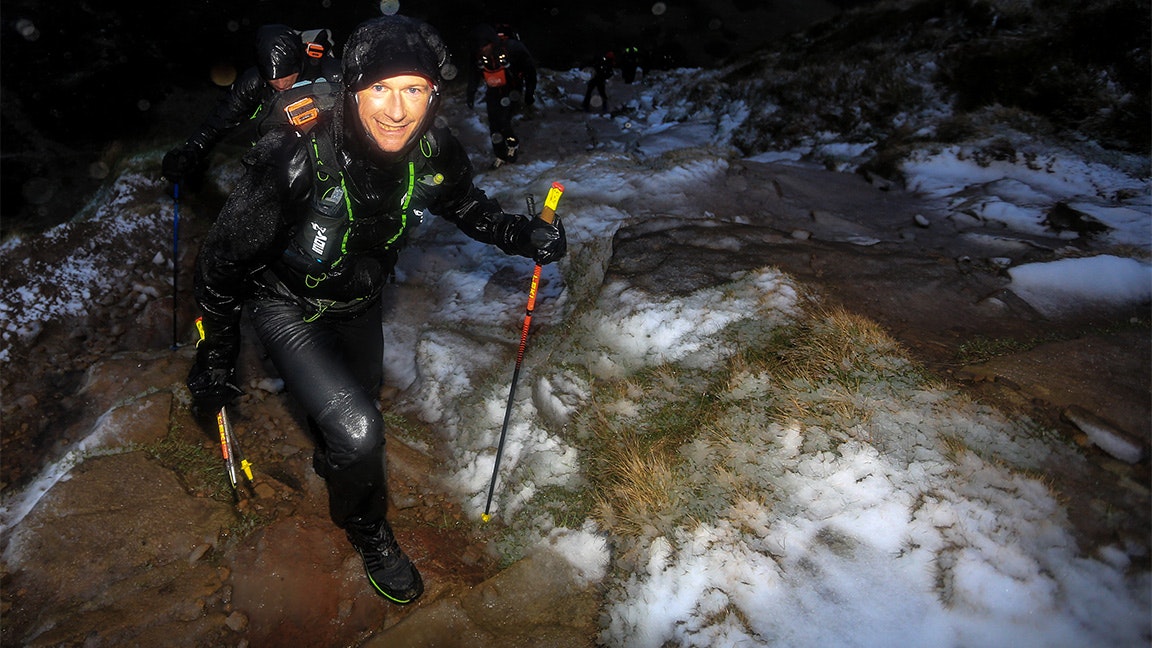 hall races spine in dark and wet conditions