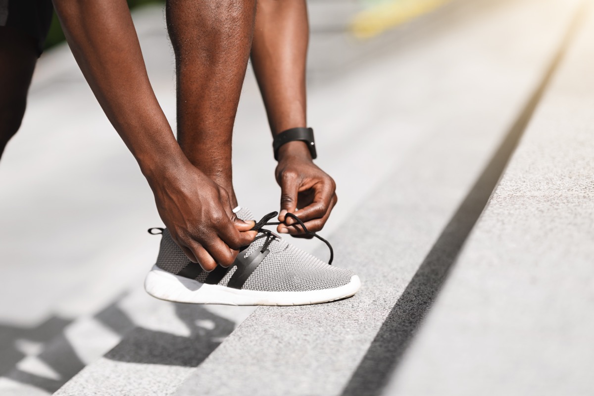 man putting on sneakers