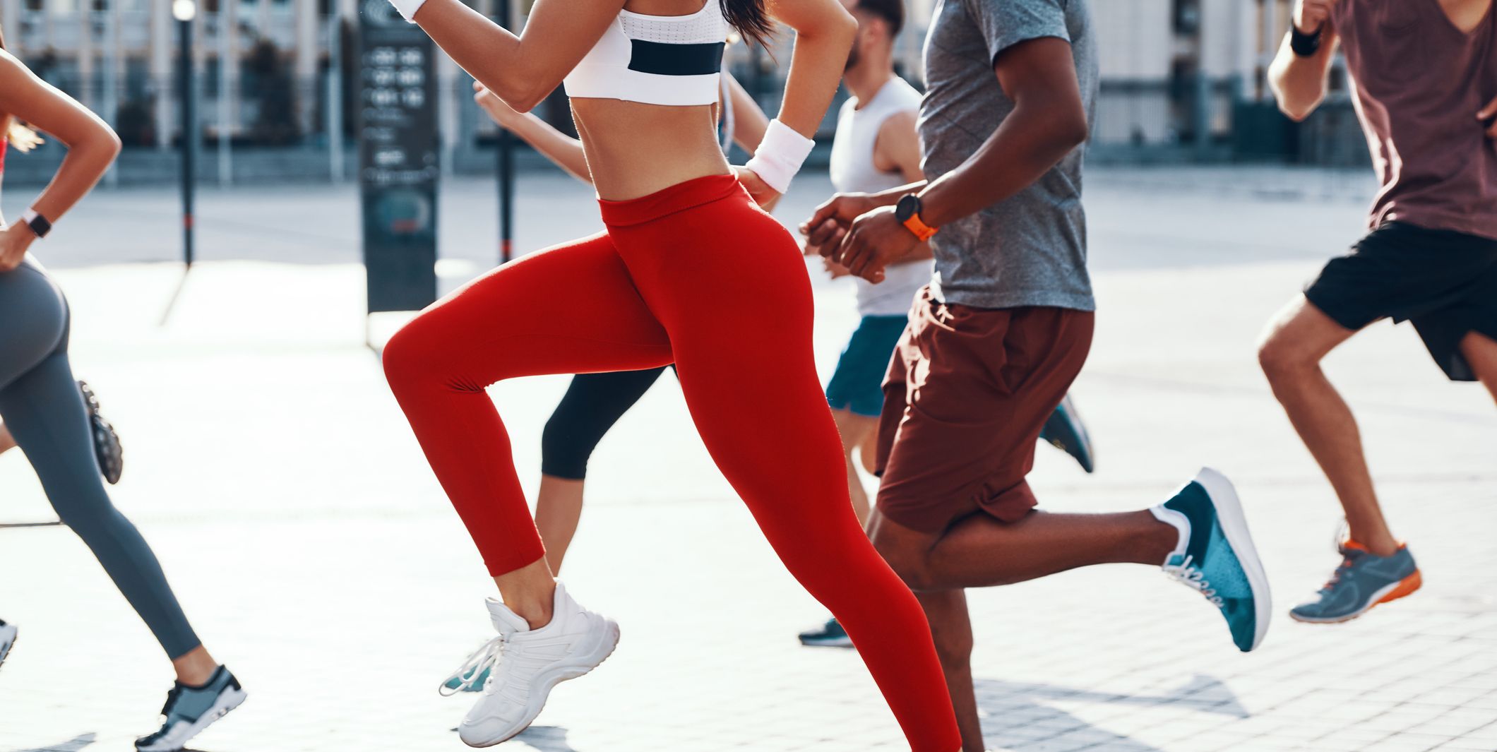 group of people in sports clothing jogging