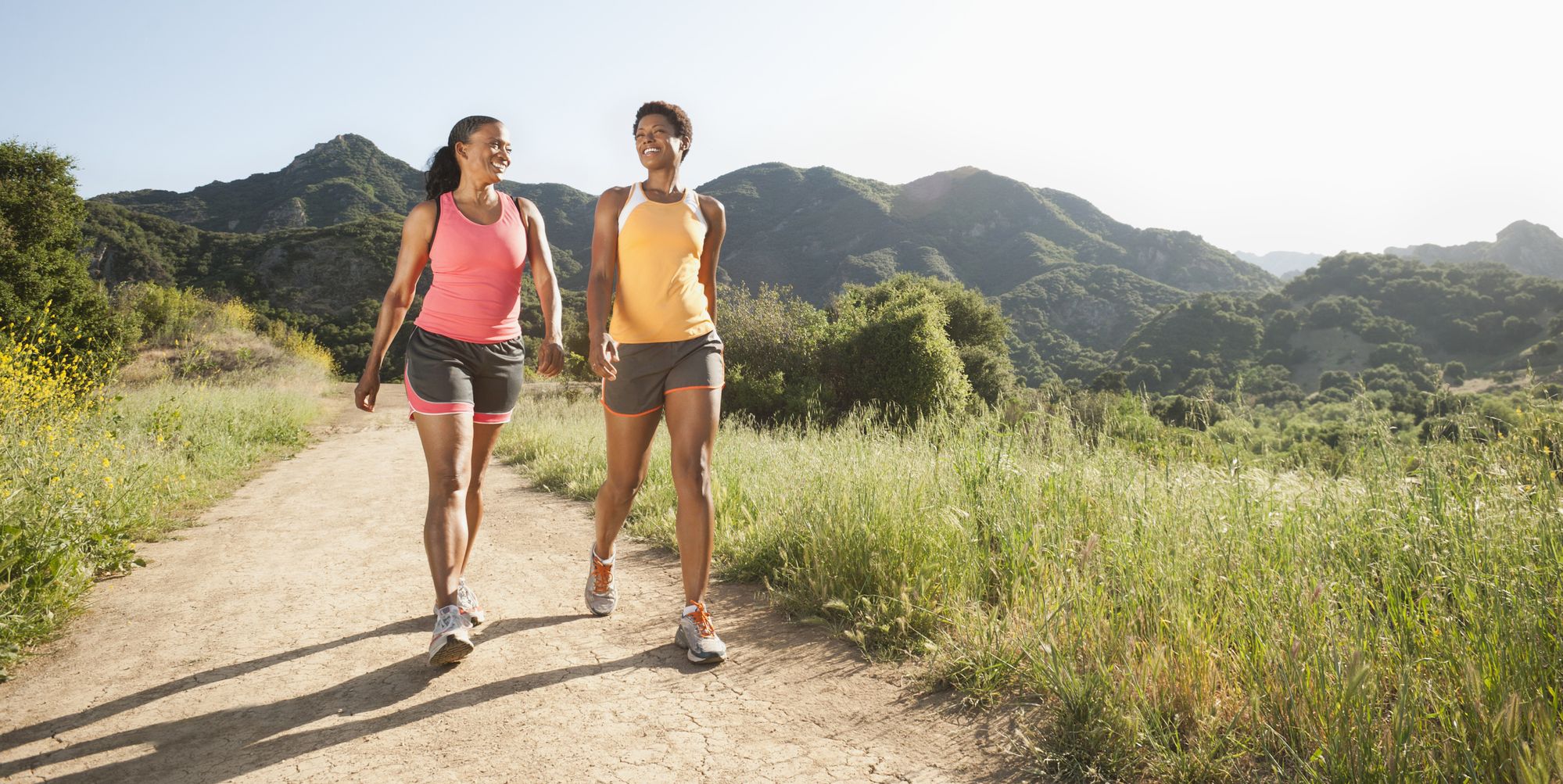 Athletic women walking together on remote trail
