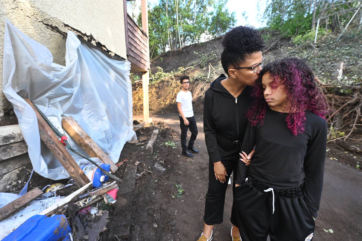 Charles family at landslide damage to apartment in Midtown