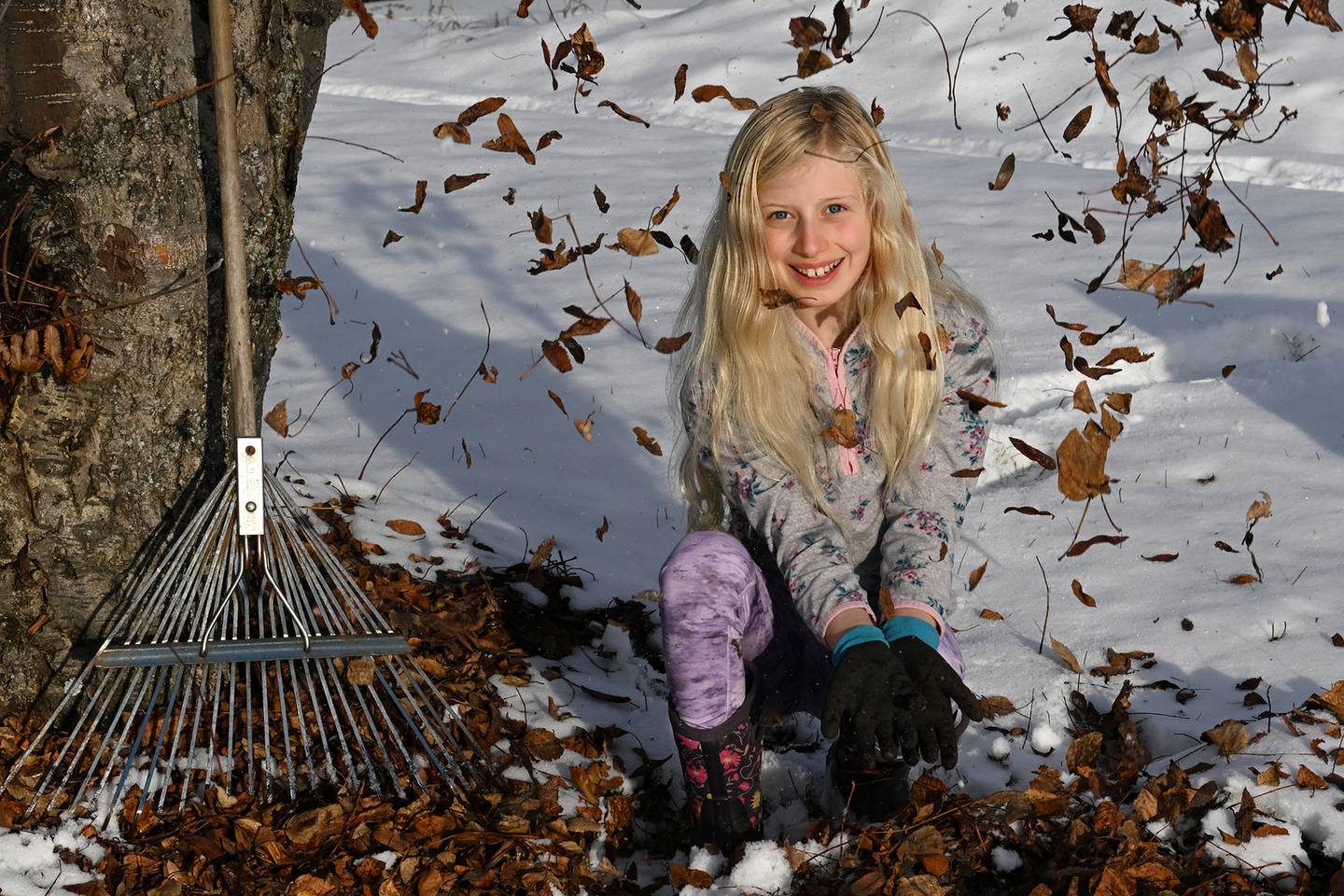 Violet Jopp rakes leaves 