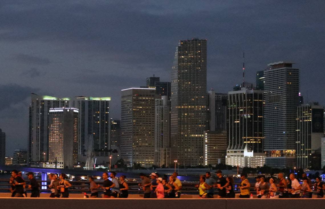 Runners head eastbound on the MacArthur Causeway as the day breaks at the 18th annual Life Time Miami Marathon and Half Marathon where runners took off in the dark at 6 a.m. Sunday, February 9, 2020 in front of AmericanAirlines Arena and finished on Biscayne Boulevard near Bayfront Park. There were more than 20,000 combined runners registered for the marathon and half marathon and the second marriage proposal during the marathon.