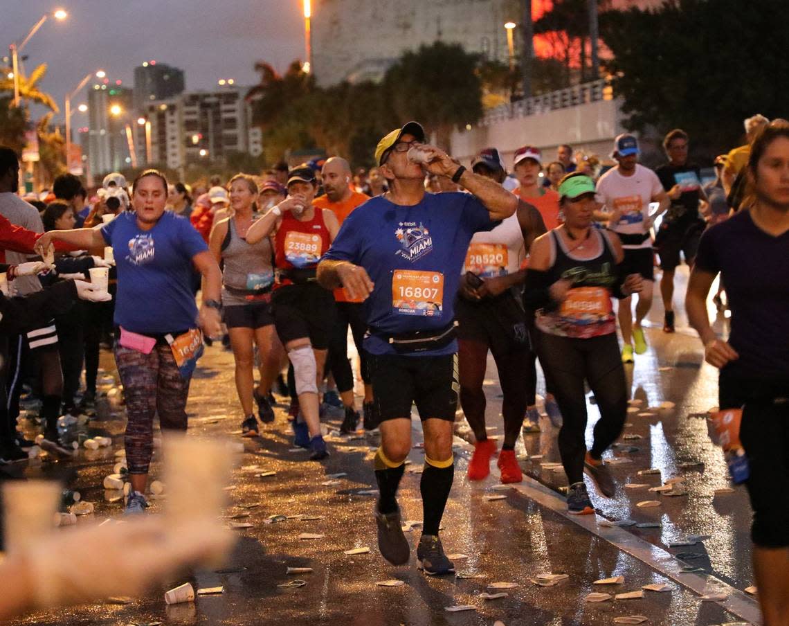 The roadway is littered by paper cups as runners reach for water while heading eastbound on the MacArthur Causeway. On Sunday, January 27, 2018 thousands of athletes participated in the 2019 Fitbit Miami Marathon and Half Marathon produced by Life Time. The full course spanned across the Venetian, Rickenbacker, and MacArthur Causeways ending at Bayfront Park in downtown Miami, Florida.