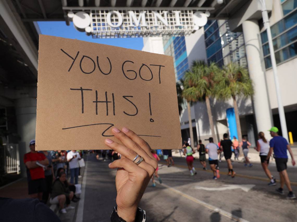 Runners pass the halfway point of the full marathon to the cheers and encouragement as they participate in the 20th annual Life Time Miami Marathon and Half Marathon on Sunday, February 6, 2022. There were more than 15,000 combined runners registered for the marathon and half marathon.