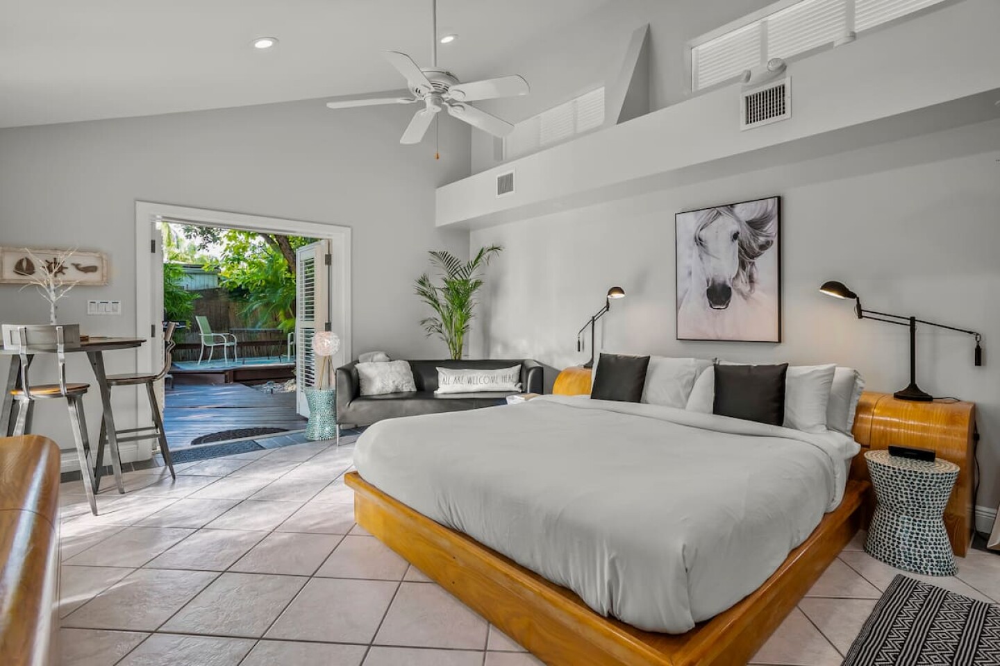 A white bedroom leading to a back patio in Key West