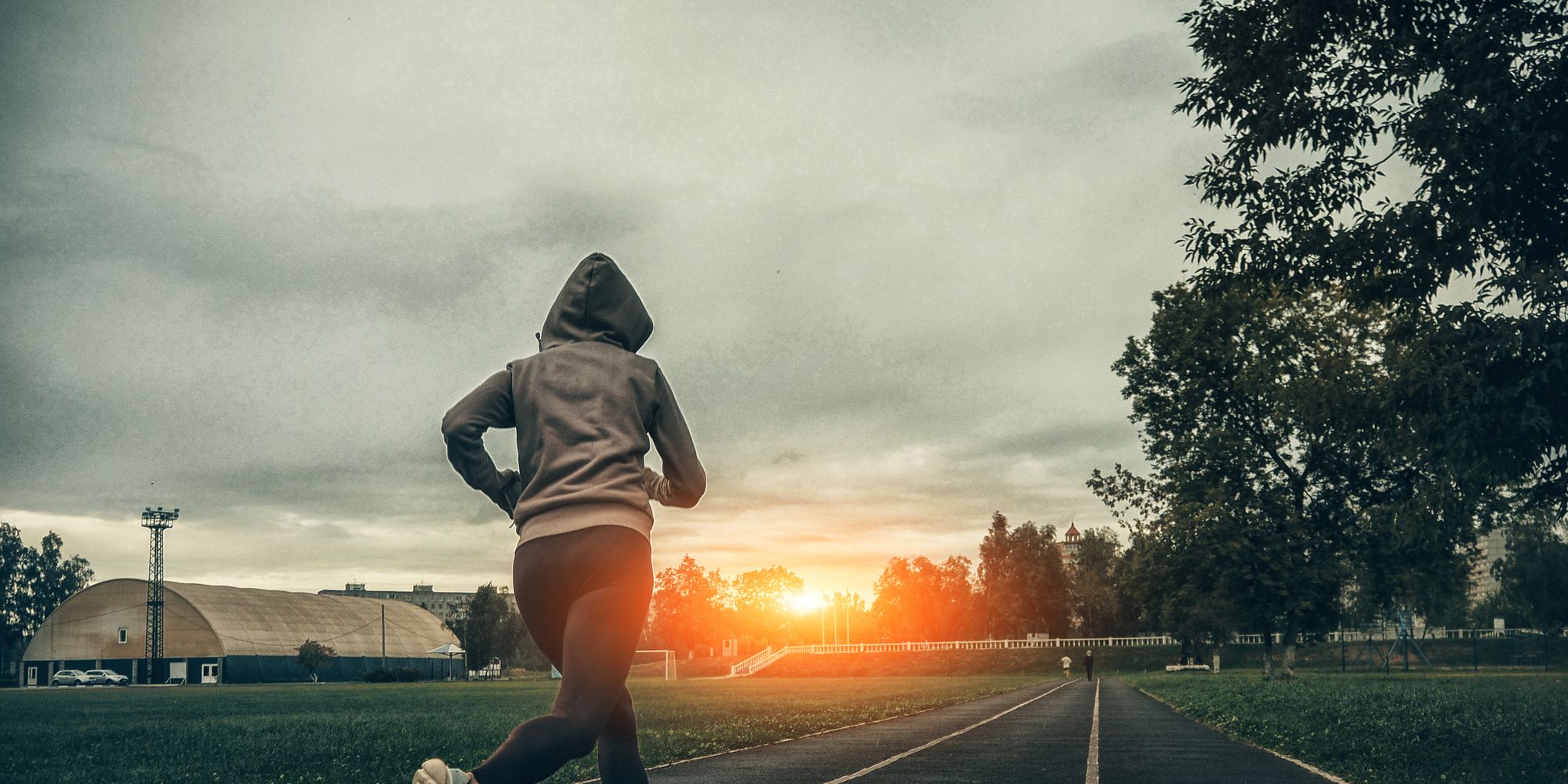 woman running on stadium track