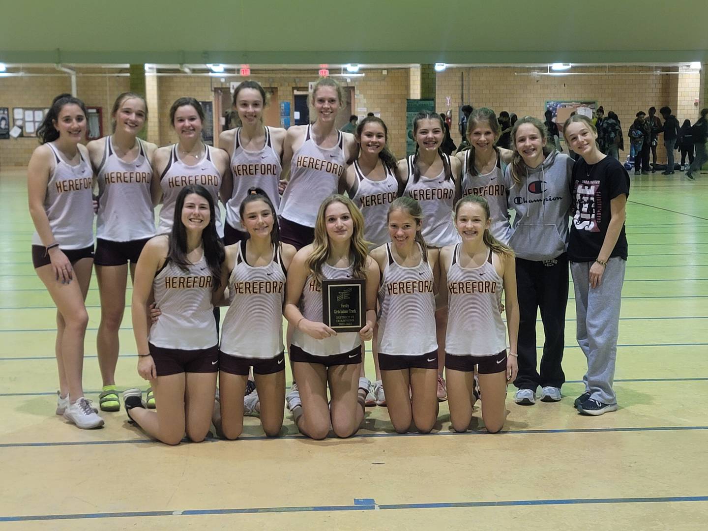 The Hereford girls indoor track and field team poses with their plaque after winning the Baltimore County championship on Tuesday.