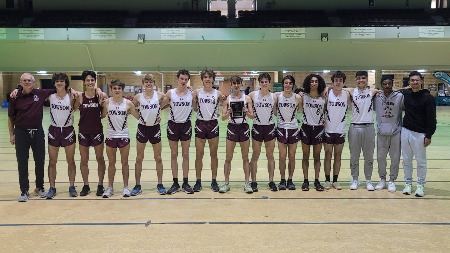 The Towson boys indoor track and field team poses with their championship plaque after winning the county championship on Tuesday.