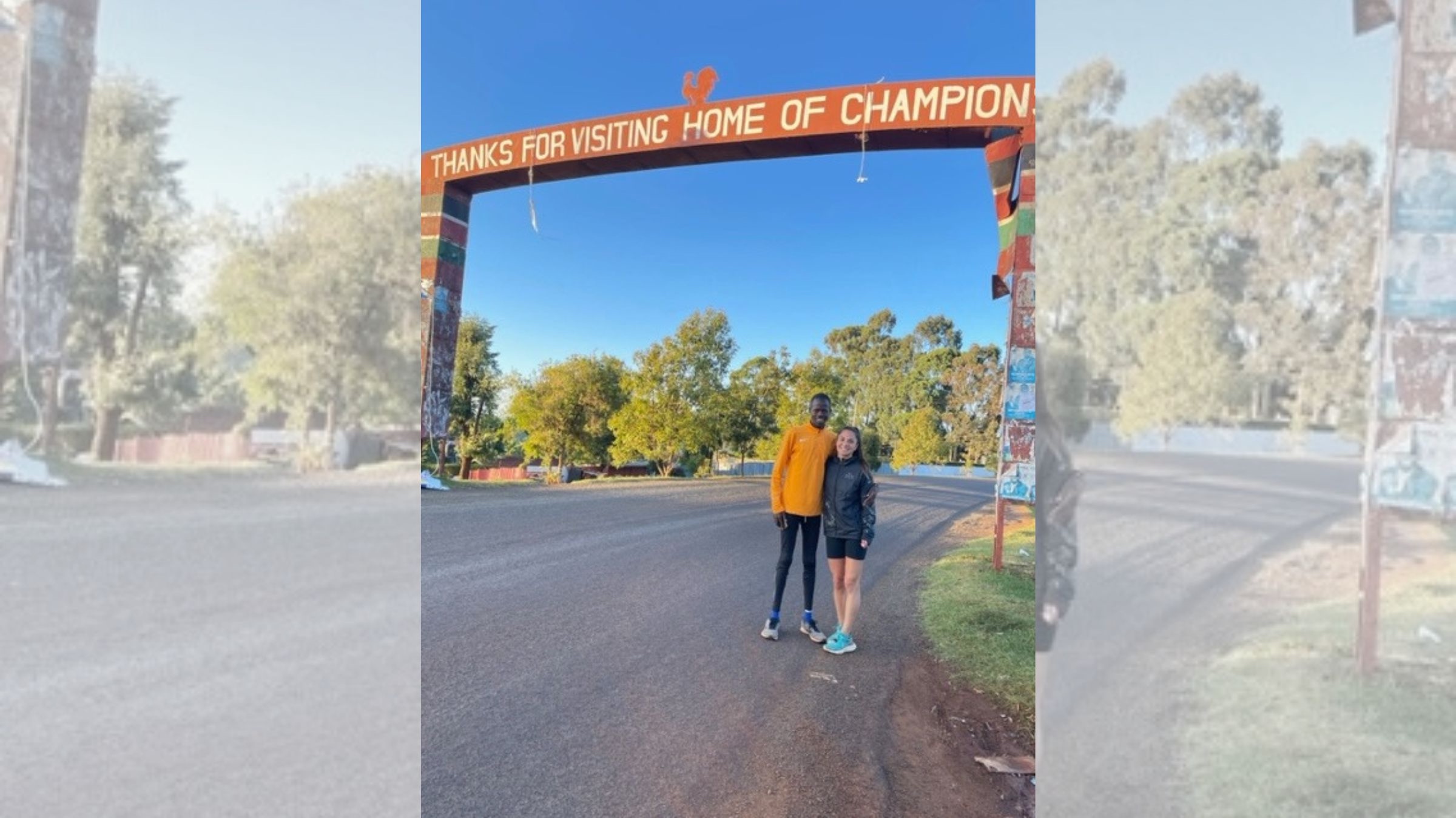 Two runners embrace under a banner on a famous training grounds in Kenya